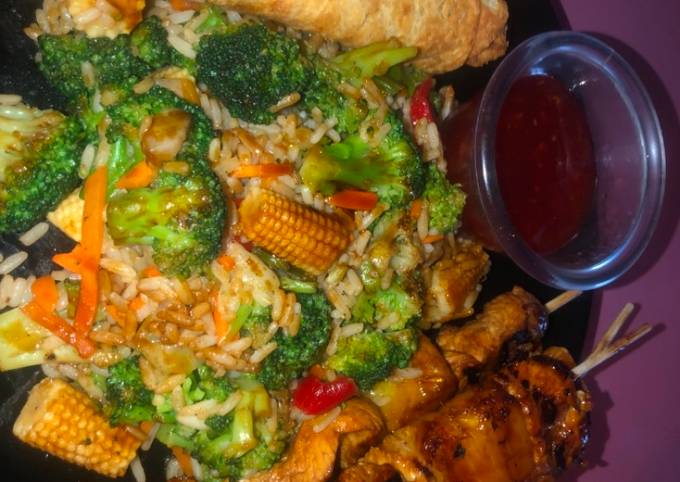 Recipe of Andrew Copley Teriyaki chicken and pineapple skewers with fried rice and veggies and eggs rolls