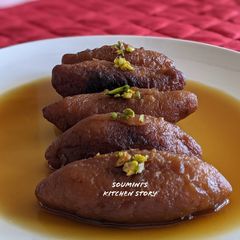A picture of Raanga Aalur Roshomoti (Sweet Potato dumplings in jaggery syrup).