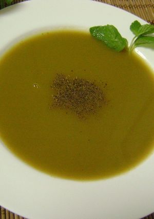A picture of Tomato Soup with Coriander Stems & Mint Leaves.