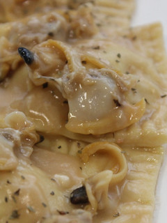 Una foto de Raviolis de gamba con almejas en salsa verde