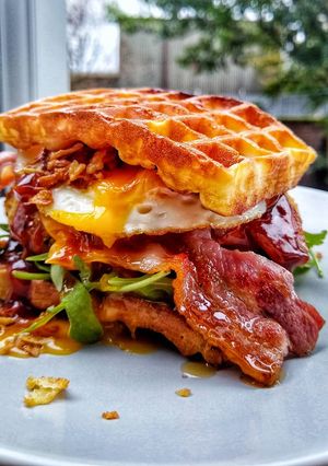 A picture of Southern Chicken Waffle Burger With Egg & Maple Glazed Bacon.