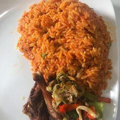 A picture of Jollof rice and stir fry veggies with chicken #hubyfavouritedish.