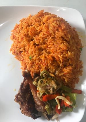 A picture of Jollof rice and stir fry veggies with chicken #hubyfavouritedish.