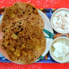 Aloo paratha with butter & curd A picture of Aloo paratha with butter & curd.