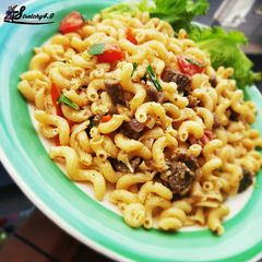 A picture of Home made coconut cheese and tomato macaroni.