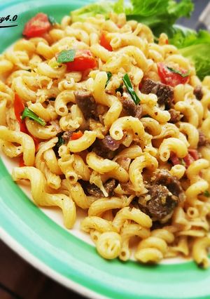 A picture of Home made coconut cheese and tomato macaroni.