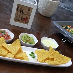 Cheese nachos with salsa and guacamole A picture of Cheese nachos with salsa and guacamole.