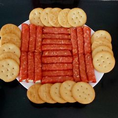 A picture of My cheese wrapped in Pepperoni and Savoury Crackers 🤩.