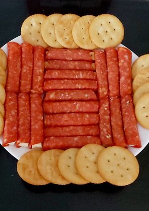 A picture of My cheese wrapped in Pepperoni and Savoury Crackers 🤩.