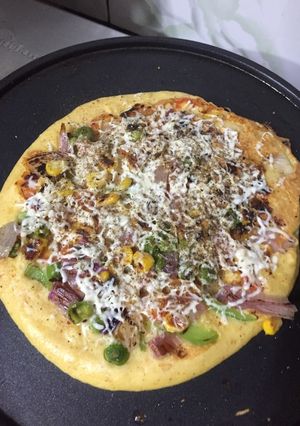 A picture of Moongdaal pizza with peas.