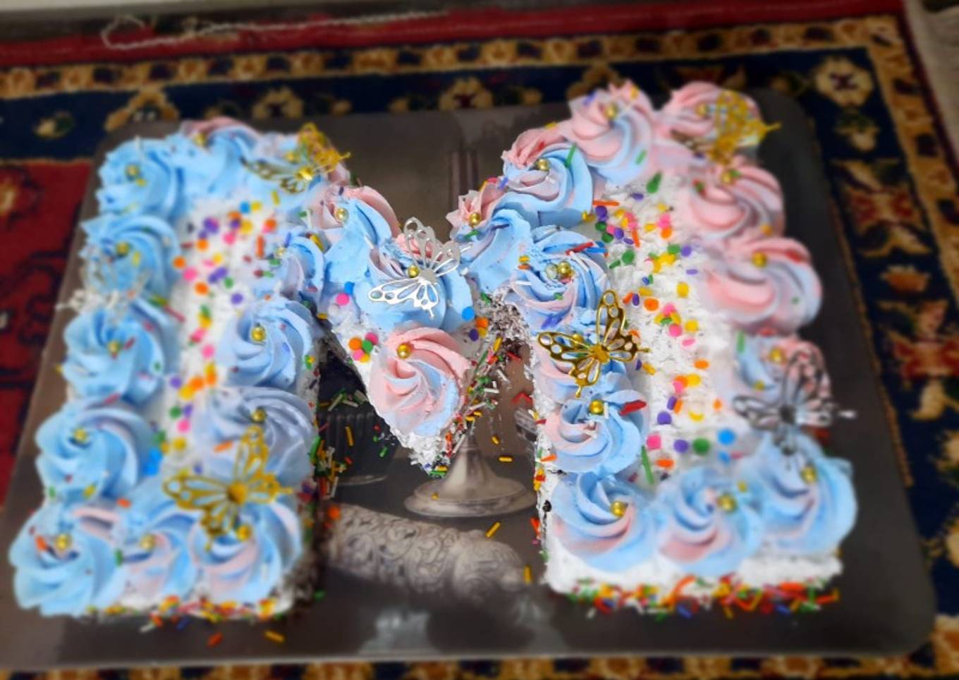 M-shaped Vanilla cake inside chocolate sponge