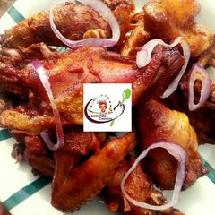 A picture of Fried chicken in tomatoe sauce.
