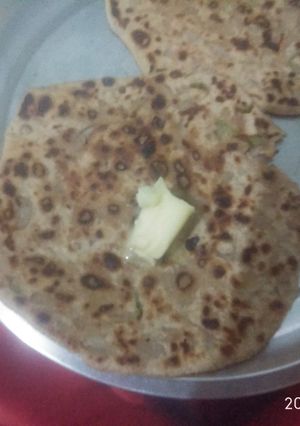 A picture of Onion paratha with butter.