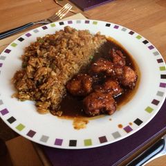 A picture of Sesame Chicken with Egg-Fried Rice.