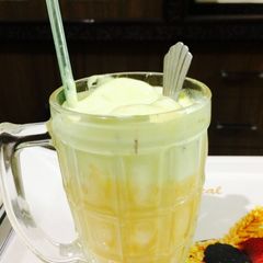 A picture of Cold coffee with mango shake and vanilla icecream.