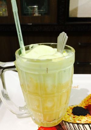 A picture of Cold coffee with mango shake and vanilla icecream.