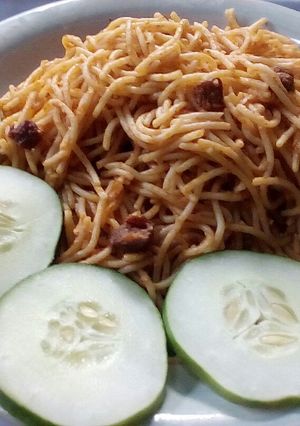 A picture of Jollof spaghetti,diced beef and vegetable.