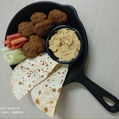 A picture of Falafel with pitta bread and hummus.
