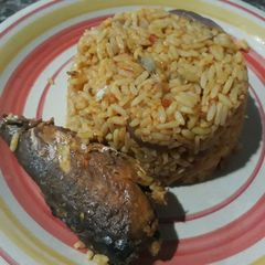 A picture of Jollof rice and fried fish.