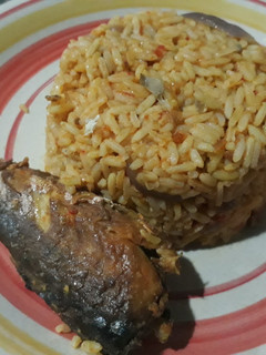A picture of Jollof rice and fried fish.