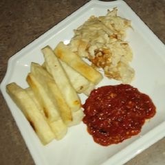 A picture of Fried yam, egg nd sauce.