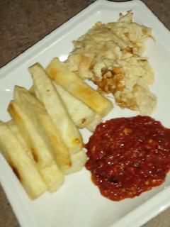 A picture of Fried yam, egg nd sauce.