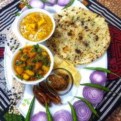 A picture of Butter paneer with naan and aloo gravy.
