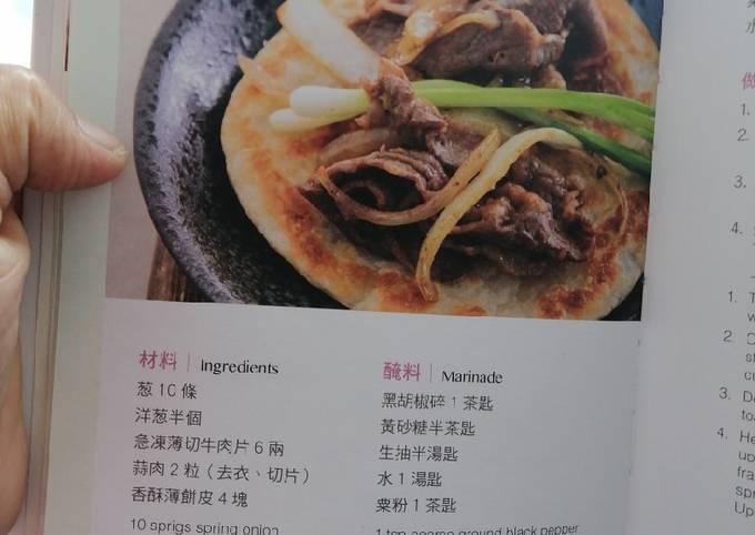 Sliced beef with white stems and spring onion