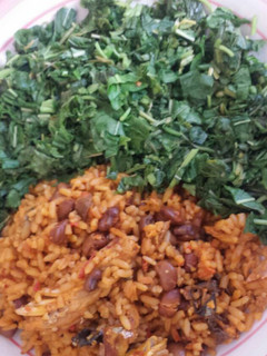 A picture of Spinach and palm oil rice with beans.