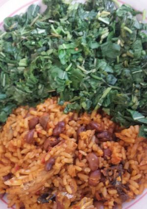 A picture of Spinach and palm oil rice with beans.
