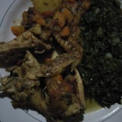 A picture of Chicken stew with greens.