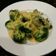 A picture of Brad's steamed broccoli with roasted hatch chile cheese sauce.