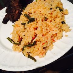 A picture of Tomato rice with beans.
