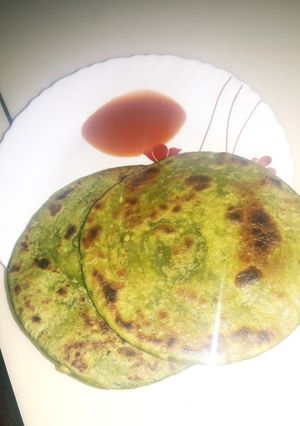 A picture of Moong dal with palok paratha.