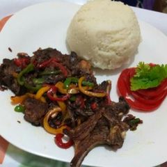 A picture of Fried Goat meat with Ugali.