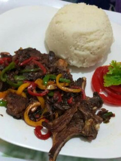 A picture of Fried Goat meat with Ugali.