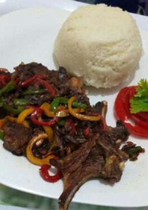 A picture of Fried Goat meat with Ugali.