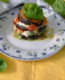 Parmigiana estiva con pesto di basilico mozzarella di bufala e pomodori cotti al forno