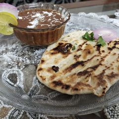 A picture of Naan with Dal makhni.