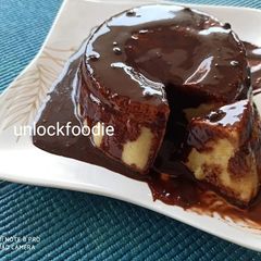 A picture of Custard Cake with chocolate Syrup.