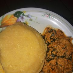 A picture of Egusi soup with eba.