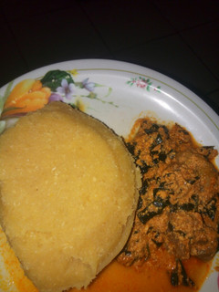 A picture of Egusi soup with eba.