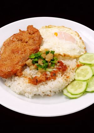 A picture of SP.0686 - Broken Rice with Caramelized Pork Chop and Sunny-Side-Up Egg.