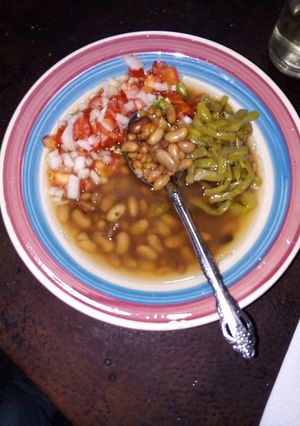 A picture of Pot Beans and Wheat with Nopales Cooked in Pulque, Epazote, and Xoconostle with Pico de Gallo.