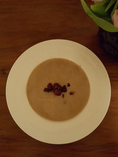 A picture of Chestnut soup with cranberry topping.