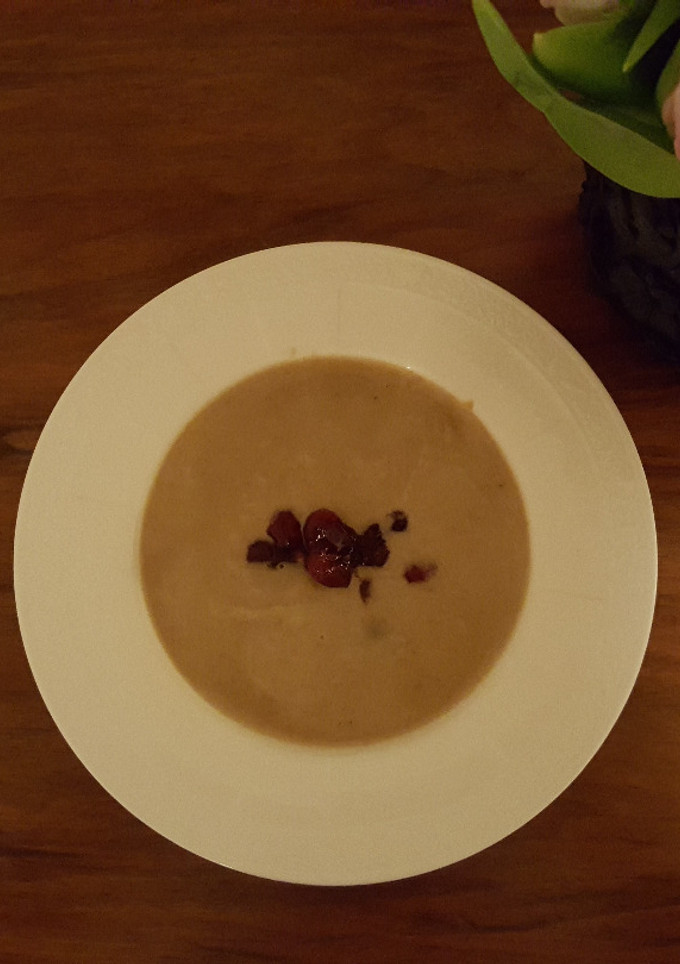 A picture of Chestnut soup with cranberry topping.