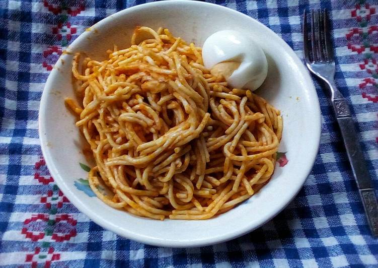 Simple jollof spaghetti and hard boiled egg