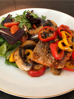 A picture of Grilled Salmon with Sautéed Mushrooms mixed Bell Peppers, and Greens Salad used BBQ Sauce.