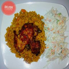 A picture of Jollof rice, coleslaw and peppered chicken.