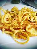Fried European Sole on a Bed of Potatoes and Garlic with Onion Rings